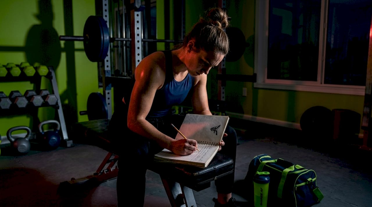 Woman logging consistent gym workout progress