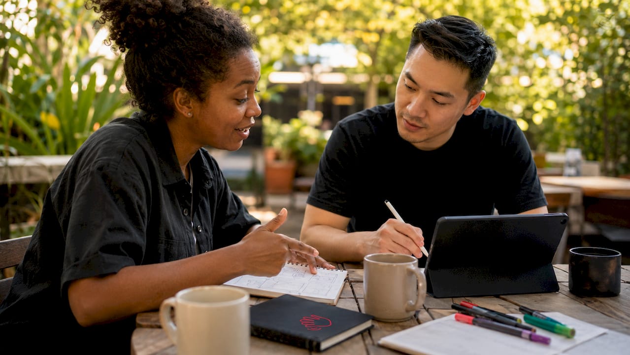 Two professionals discussing brand foundation plan
