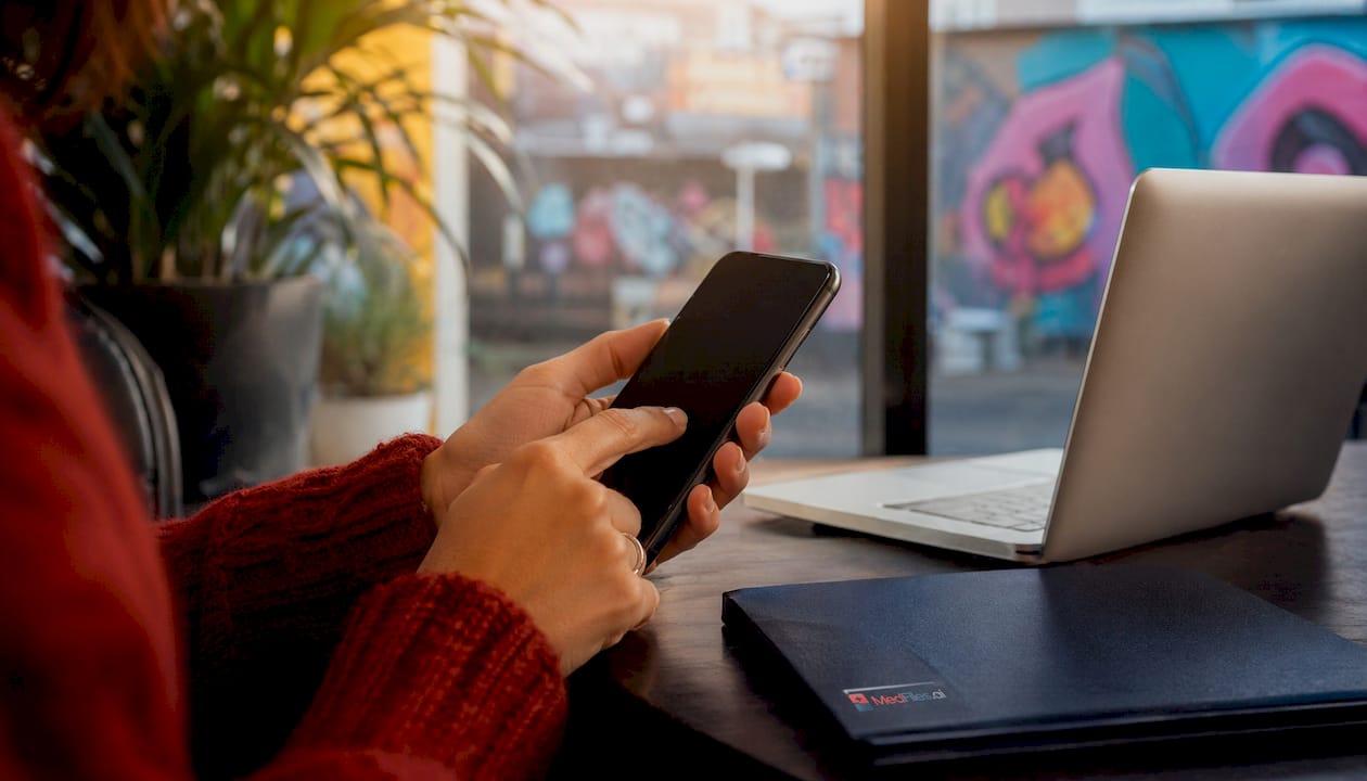 Hands using smartphone, emphasizing password app