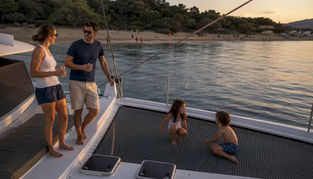 Family enjoying safe catamaran trampoline