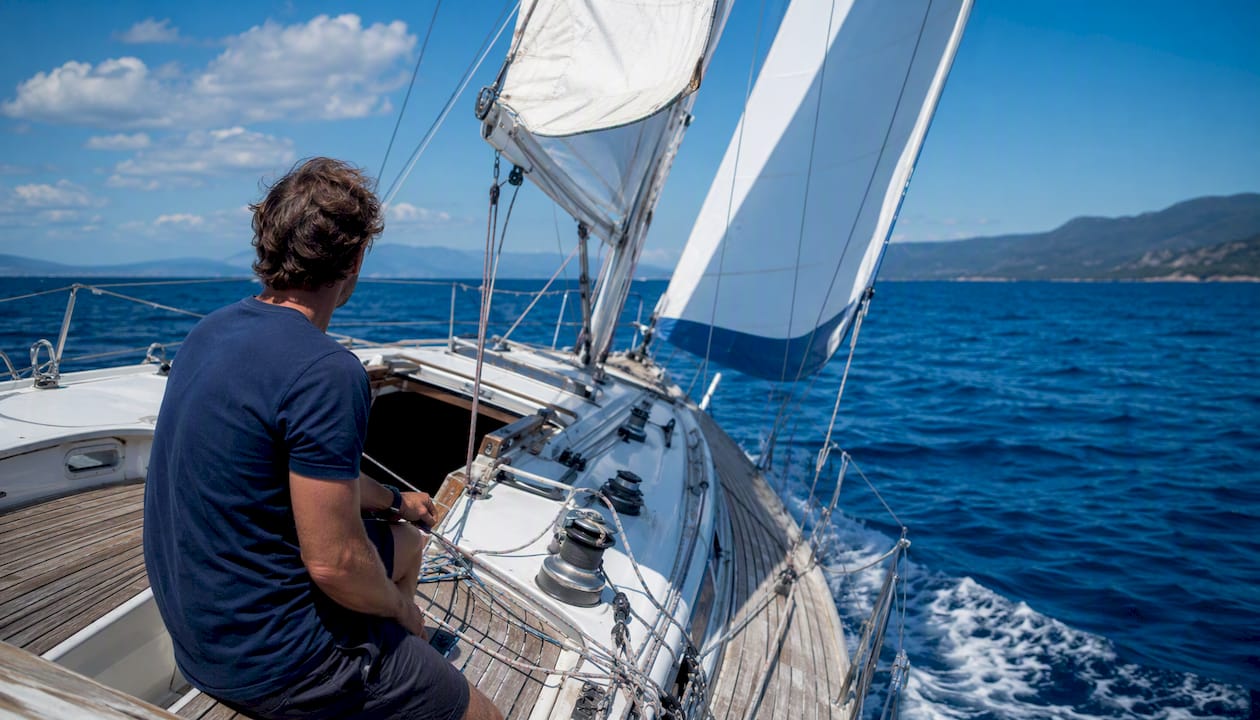 Sailboat close-hauled heeling over water