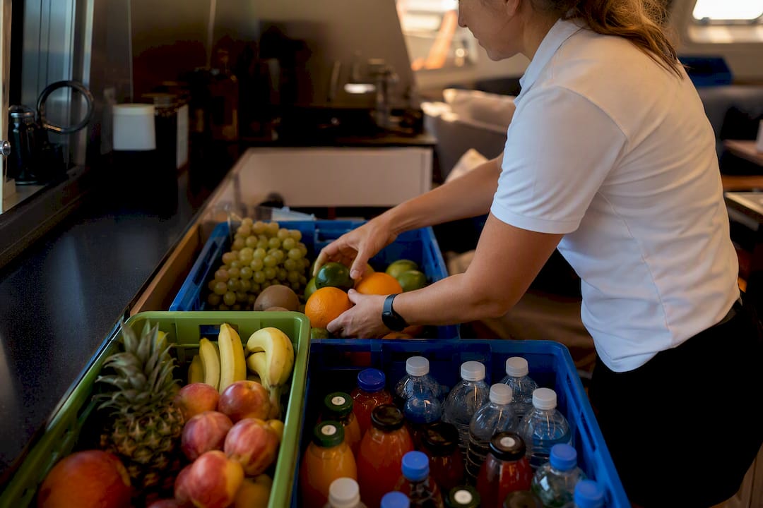 Crew hands checking yacht galley provisions