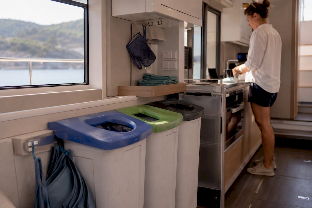 Yacht galley waste sorting bins and reusable containers