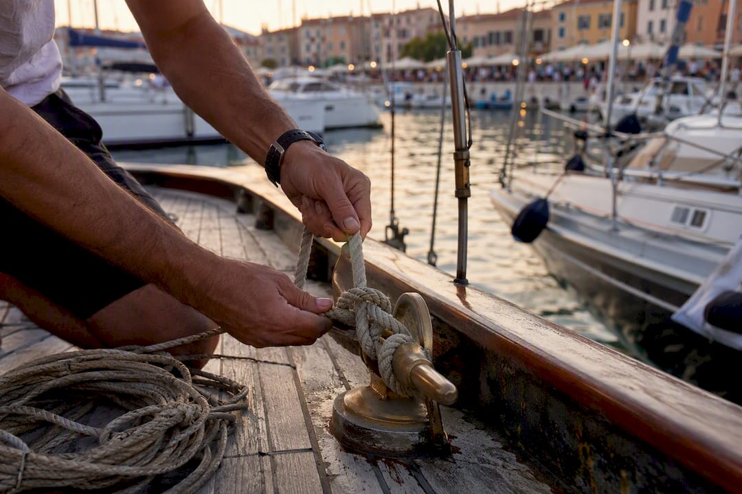Hands tying bow line during docking
