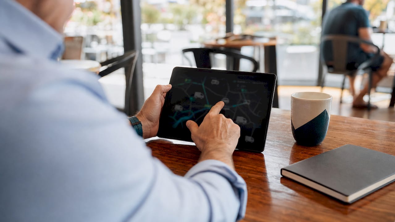 Analyst interacting with telematics dashboard on tablet