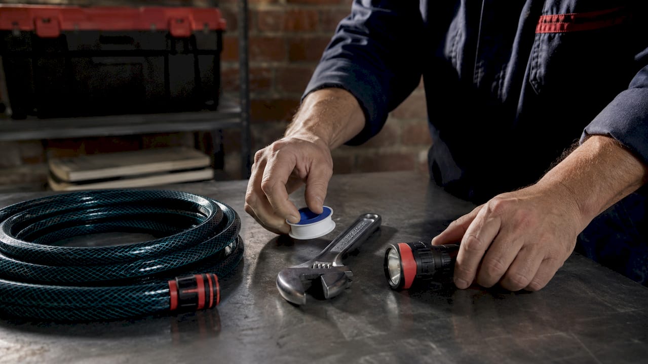 Plumber arranging water heater maintenance tools