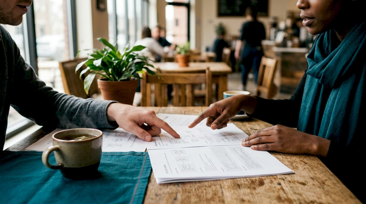 Close-up hands pointing at API logistics documents