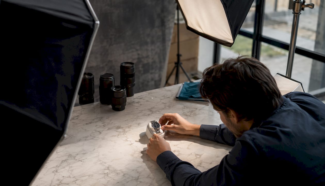 Hands adjusting product lighting setup