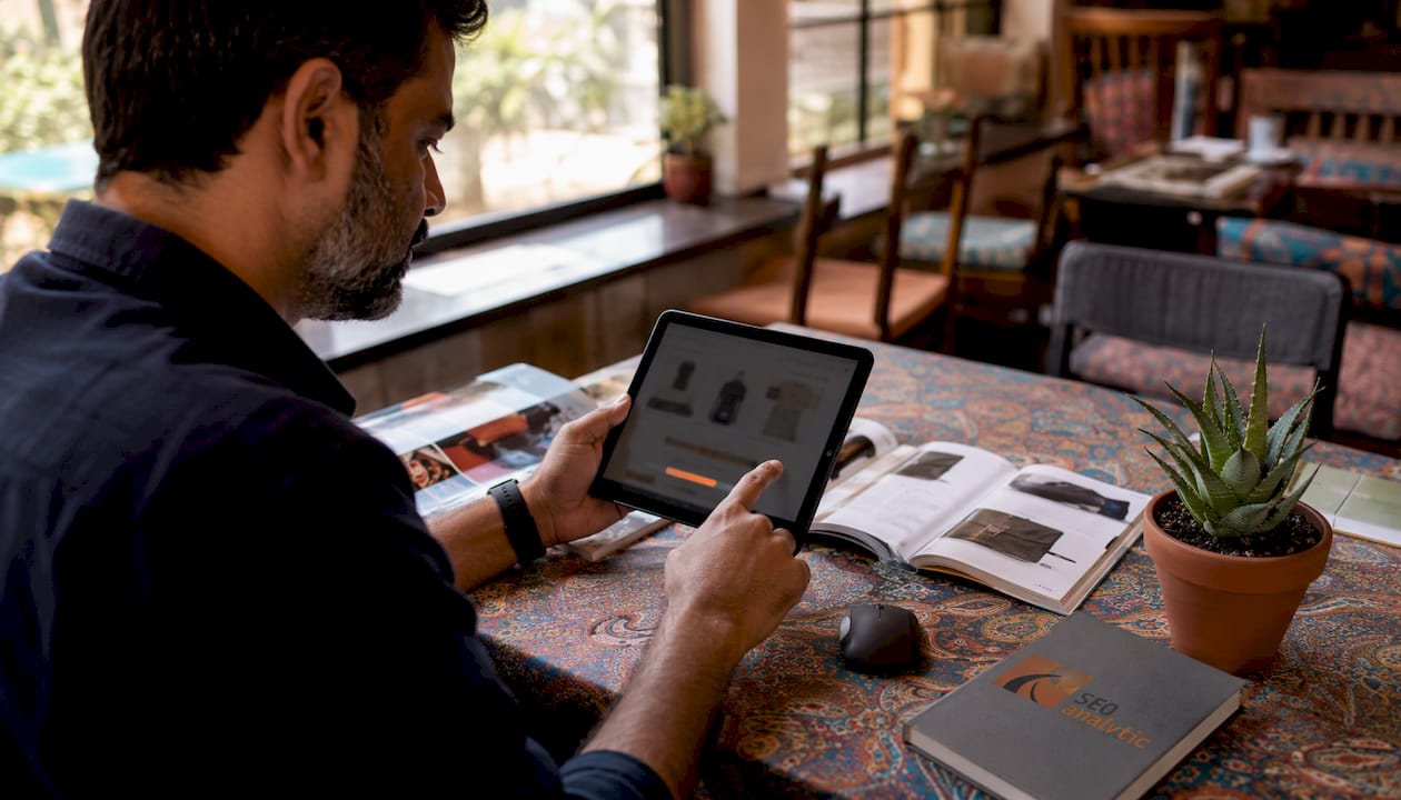 Hands adjusting free shipping progress bar on tablet