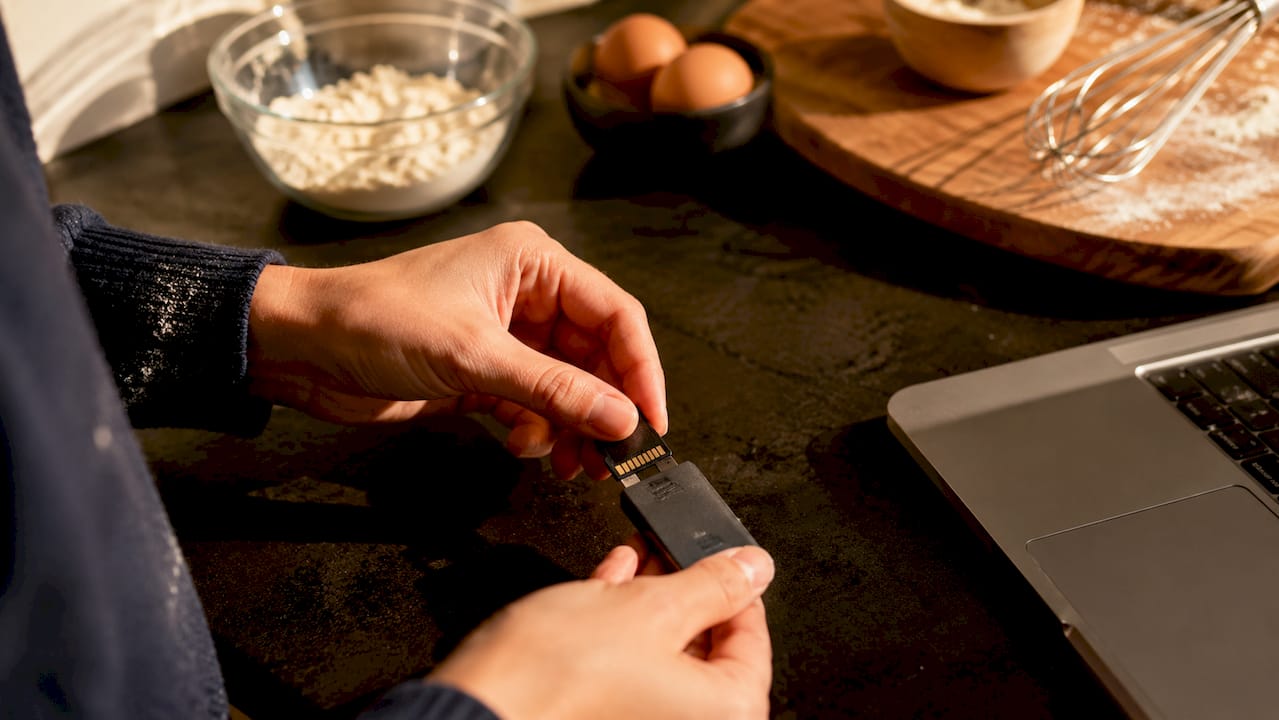 Memory Card Data Retrieval Process: 2026 Guide 4 Hands inserting memory card into USB reader