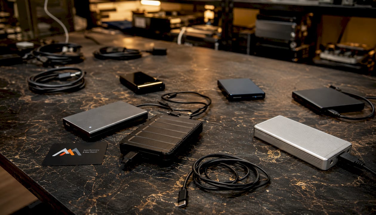 Best TechCare Computers Alternatives for Mac Users in 2026 5 External hard drives connected with cables on black surface