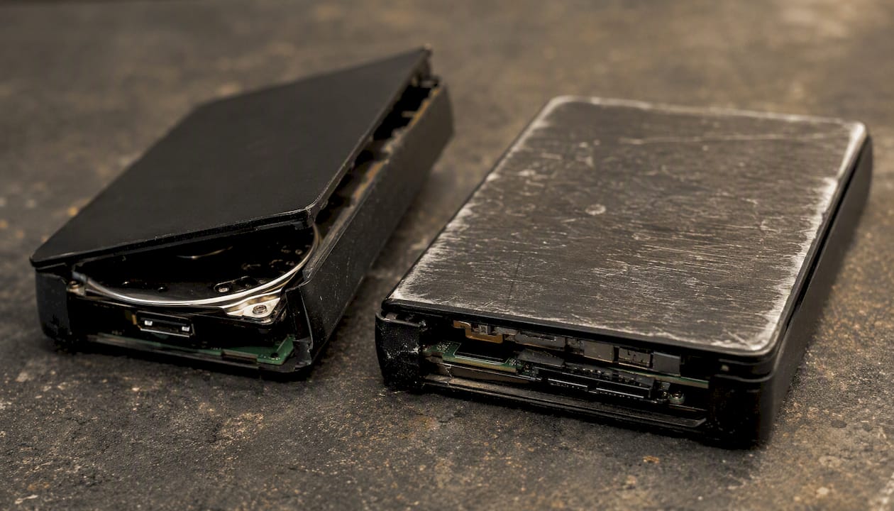Lost Partition Recovery on Mac: 2026 Step-by-Step Guide 3 Close-up damaged external hard drives on bench