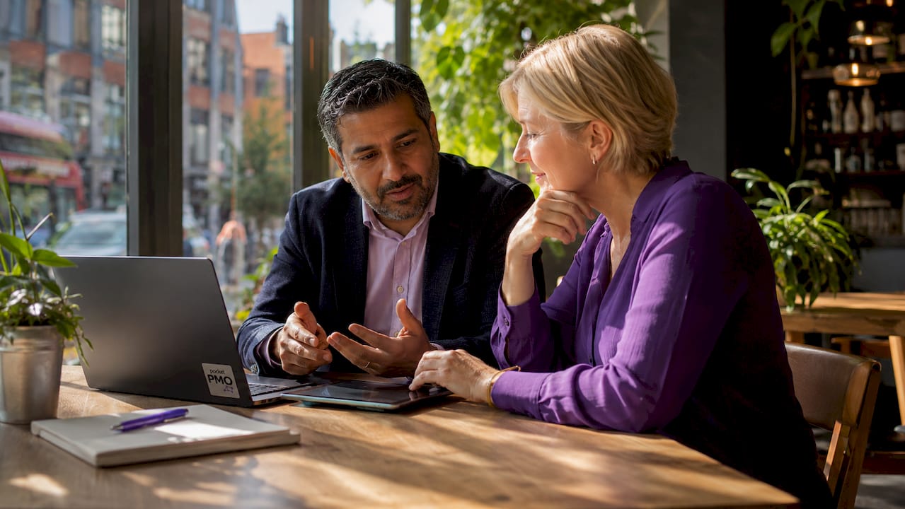 Two leaders discussing risk management chart