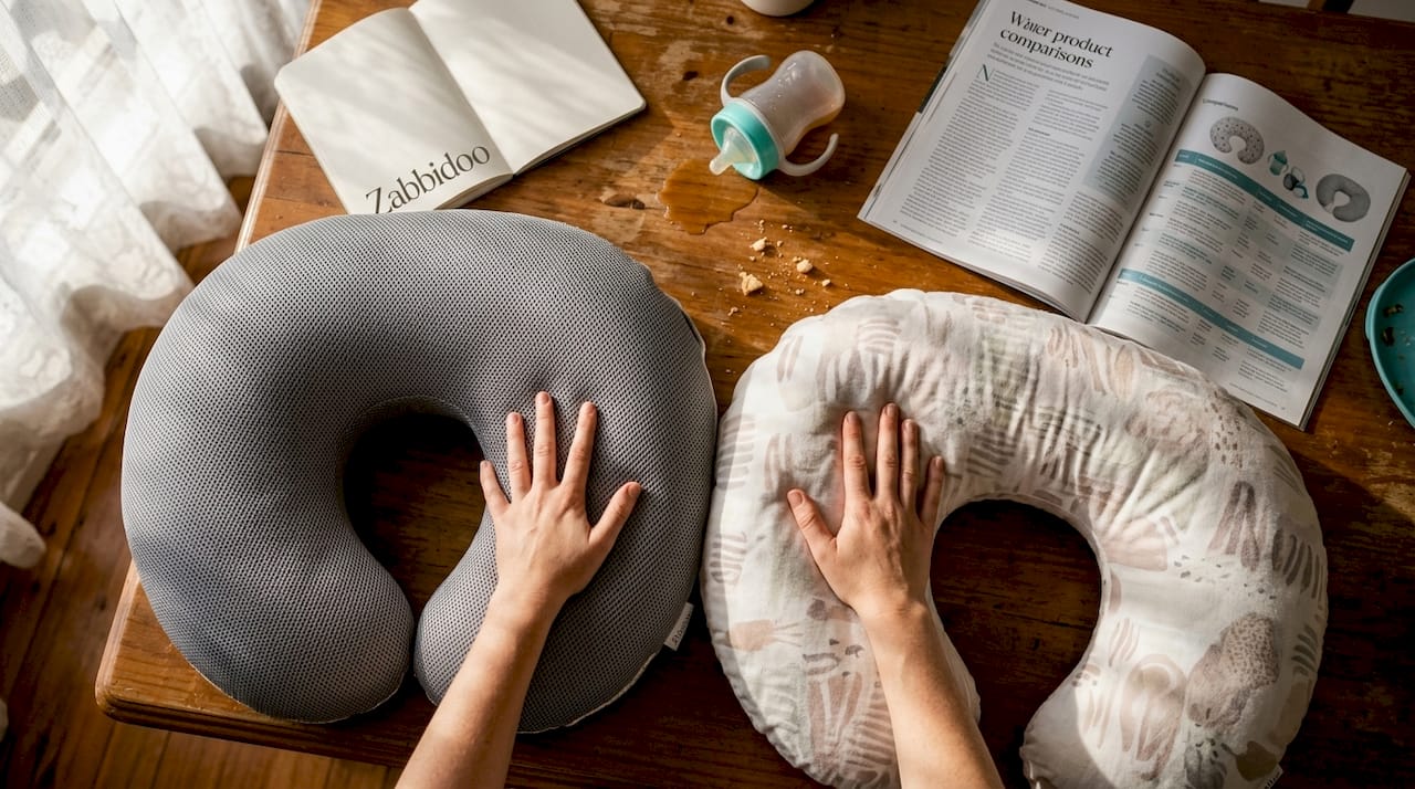 Hands comparing nursing pillow materials