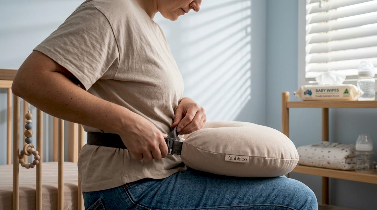 Flat firm nursing pillow strapped for feeding support