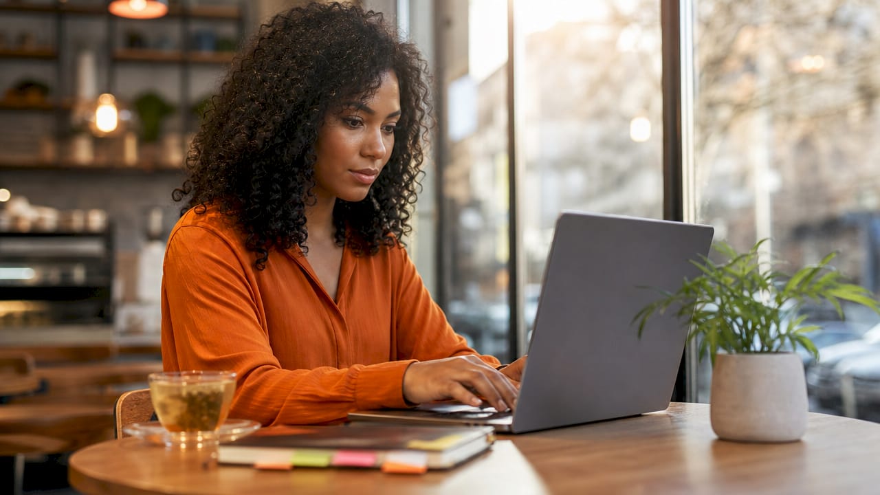 Hands operating resume screening on laptop