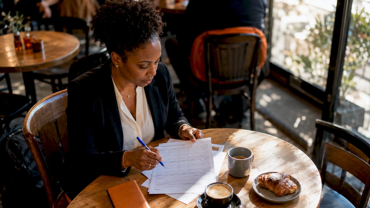 HR manager scoring candidate evaluations at desk