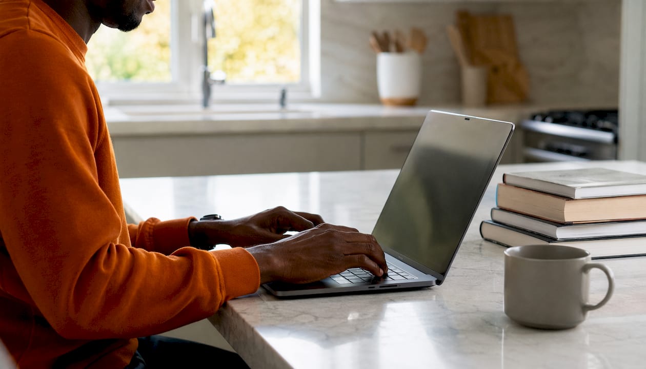 Close-up of hands typing AI-assisted tasks