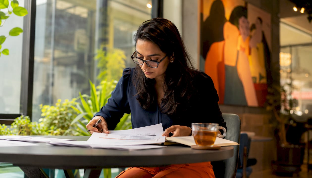 HR professional reviewing candidate scorecards at desk