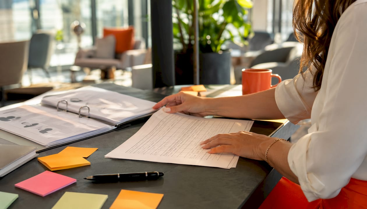 Recruiter assembling hiring scorecard with notes