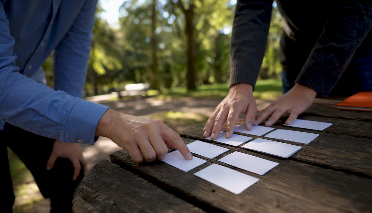 Hands comparing printed scorecards in pilot session