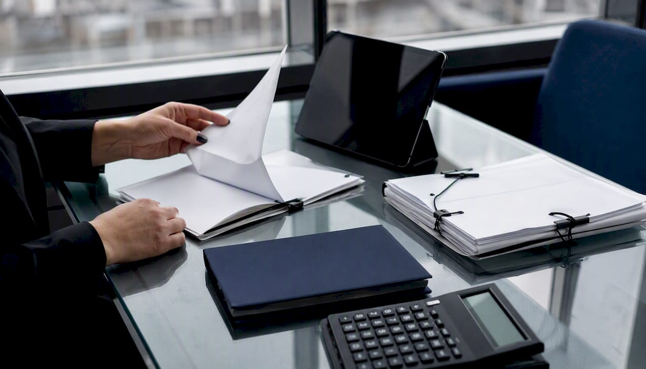 Hands handling mortgage collateral documents
