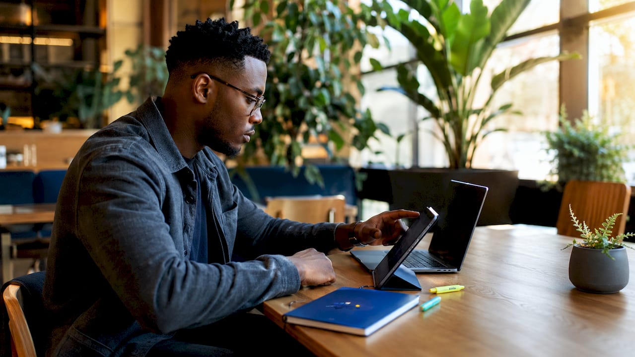 Trader interacting with charts using touchscreen laptop