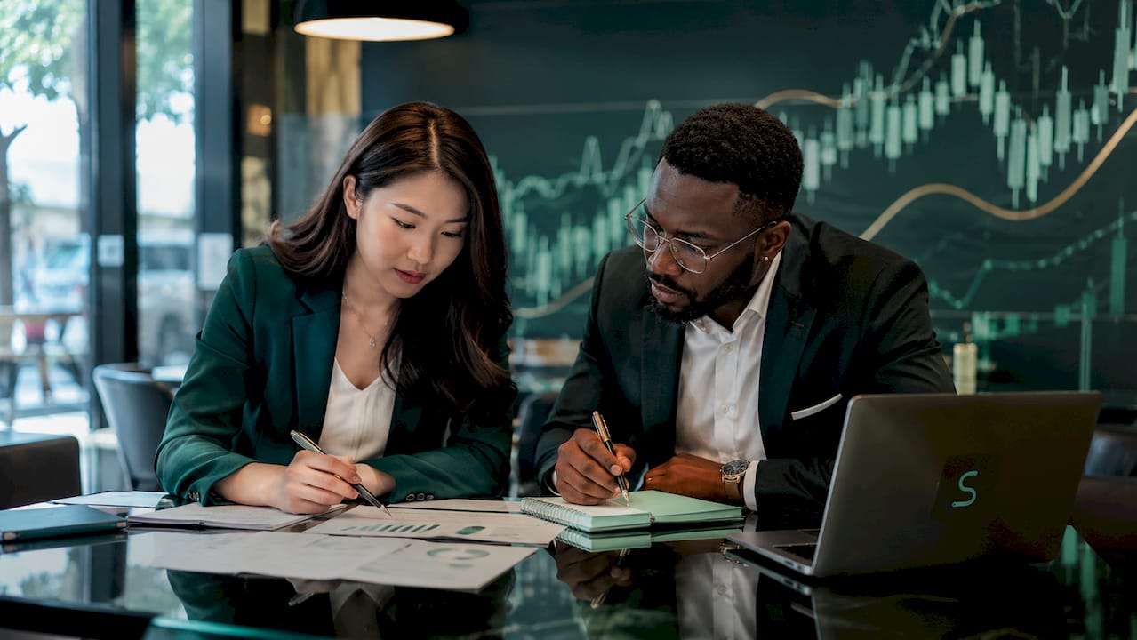 Professionals discussing market volatility triggers
