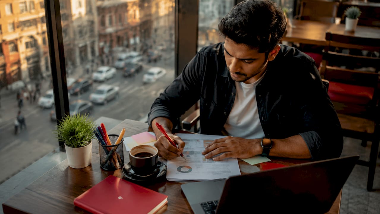 Why Hire Indian Digital Marketers: A 2026 Guide 3 Indian digital marketer working at office desk