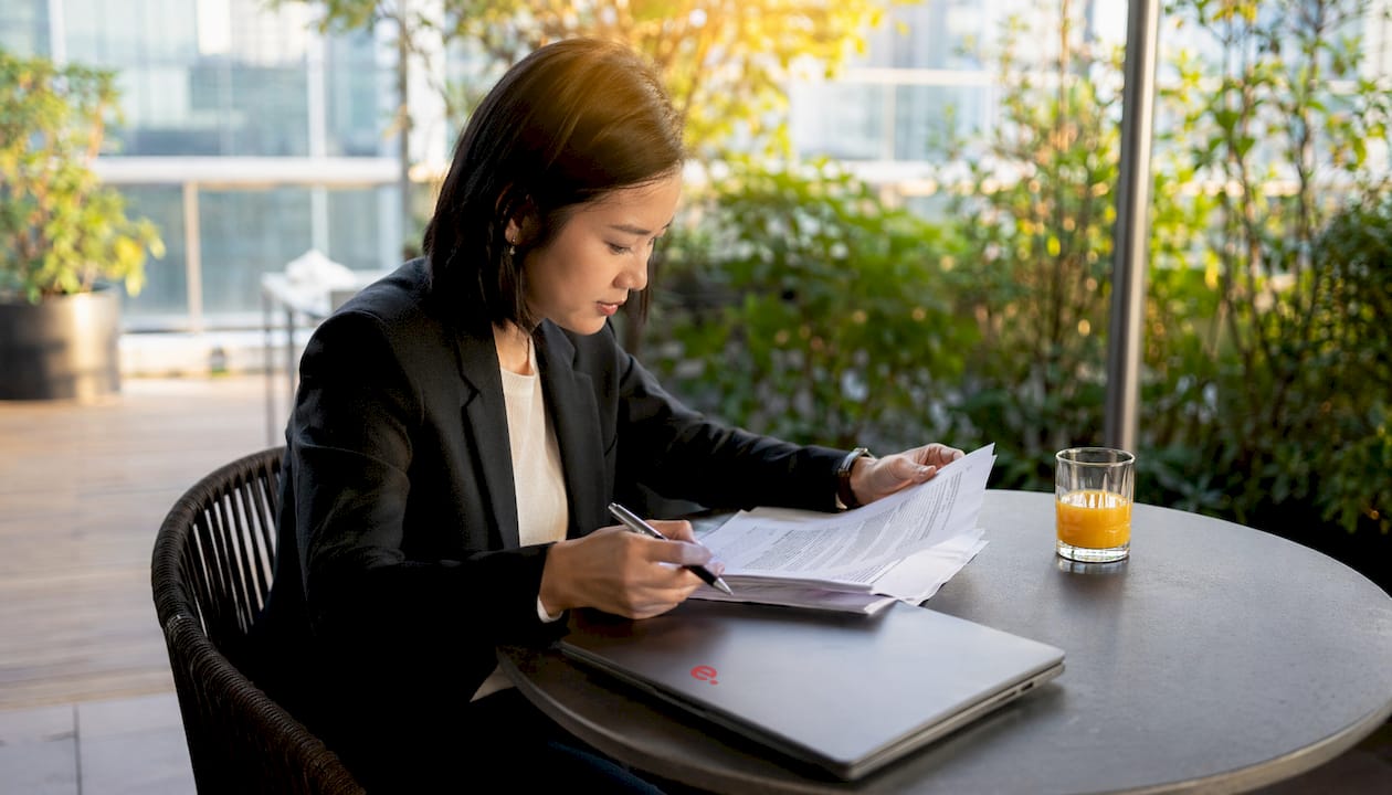 Executive reviewing benefits documents at desk