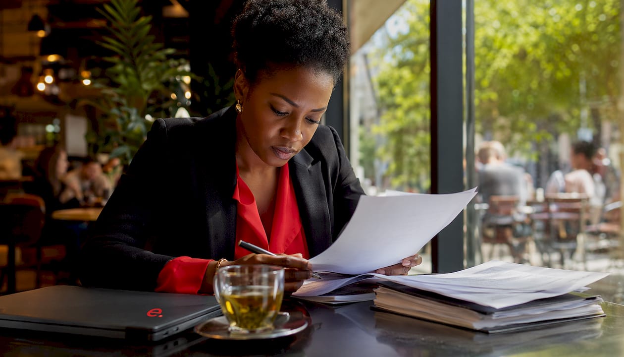 How to Stay Compliant Hiring Internationally in 2026 3 Woman reviewing international hiring compliance documents