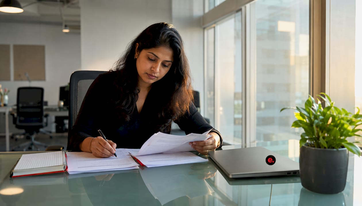 Offshore Team Integration Best Practices for Tech Leaders 2 Woman reviewing onboarding documents at desk
