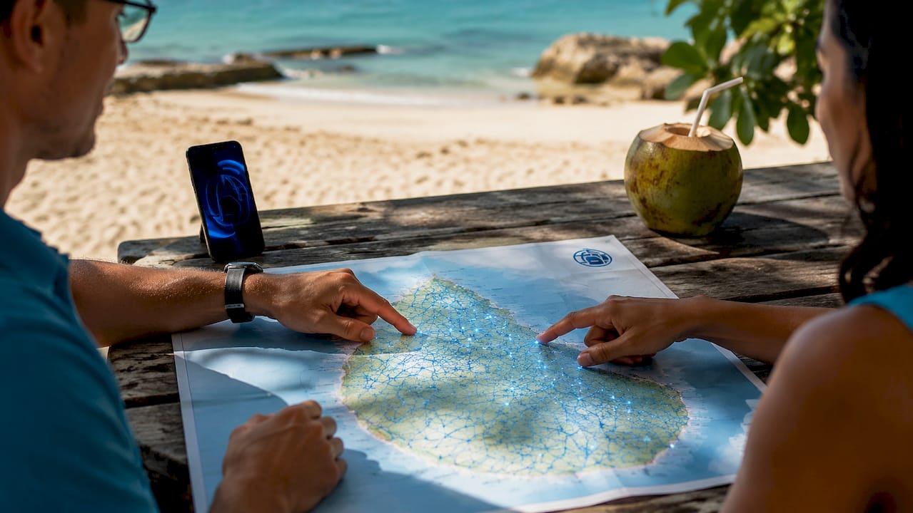 Hands pointing at Barbados map near phone