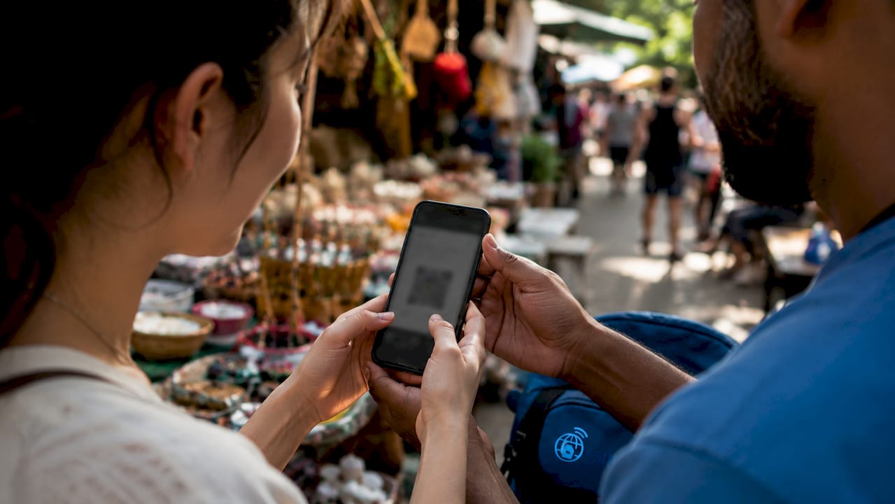 Hands holding smartphone activating eSIM indoors