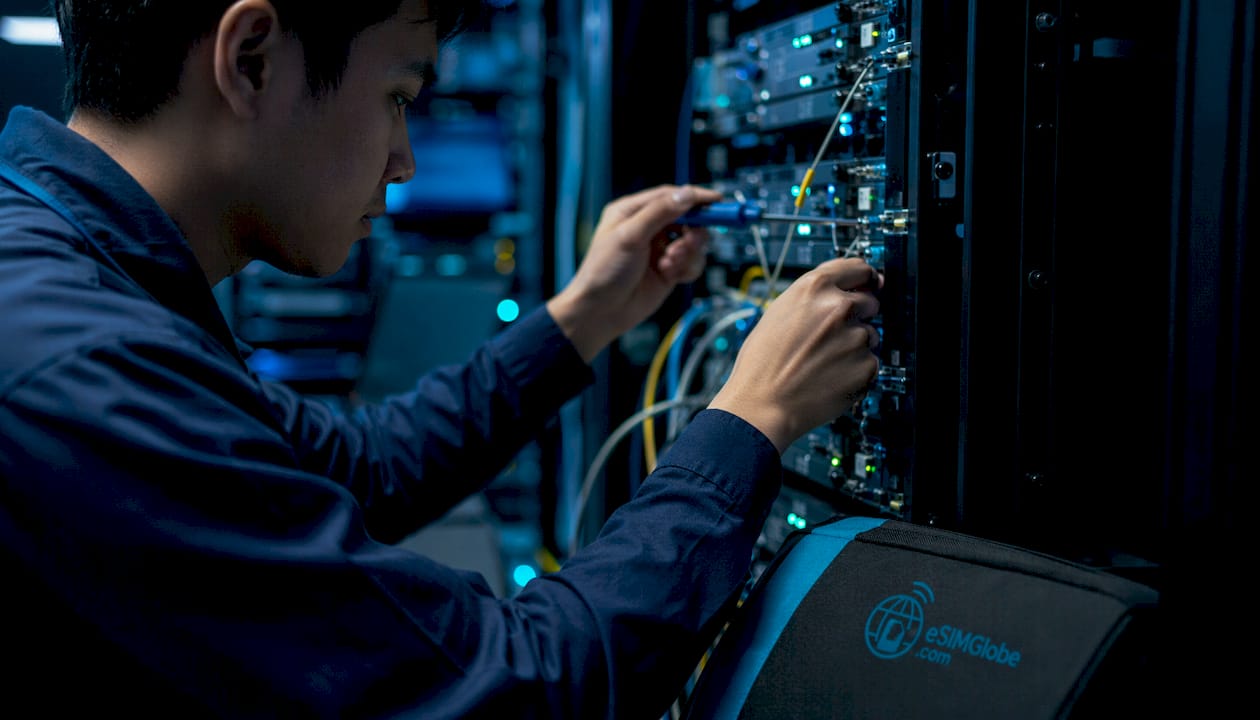 Technician managing ISP network equipment cables