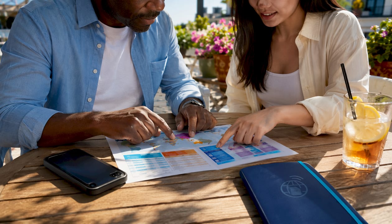 Hands pointing at travel eSIM plan chart