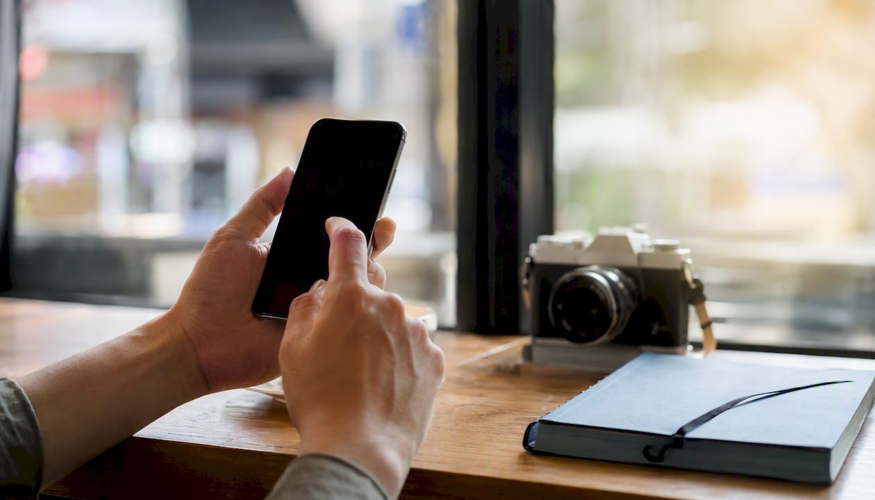 Hands toggling airplane mode on smartphone