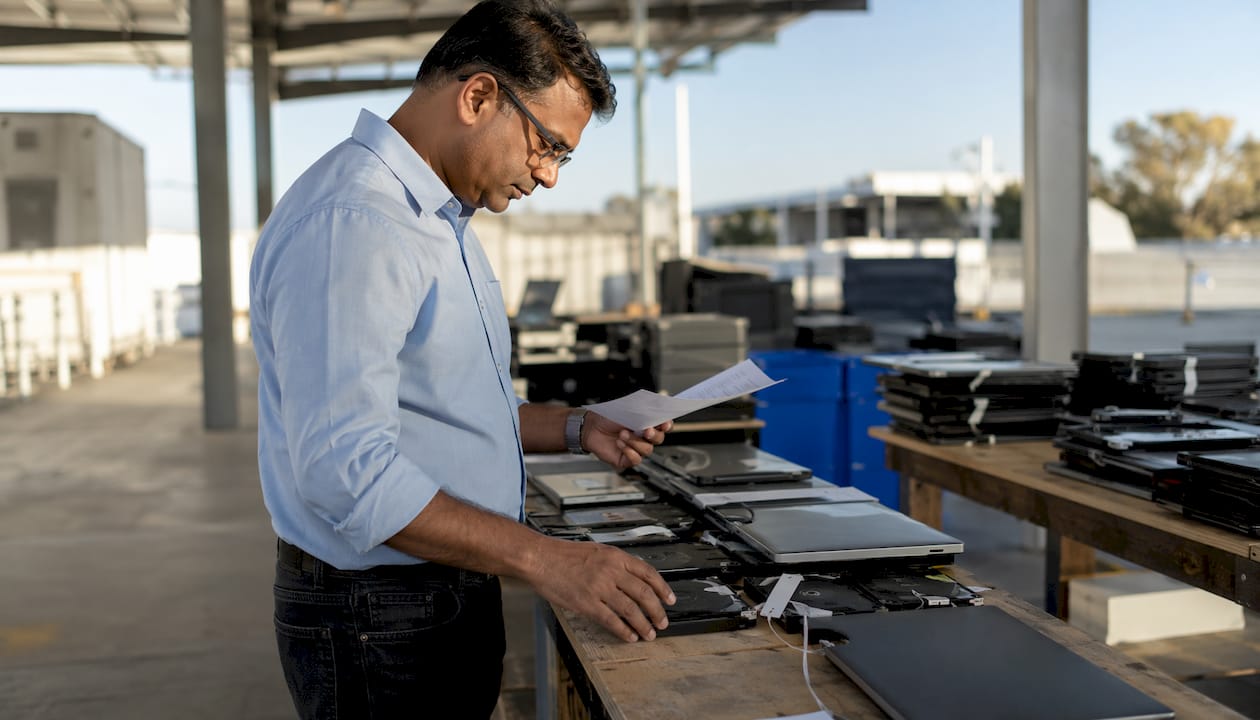Coordinator inspecting IT assets for disposition