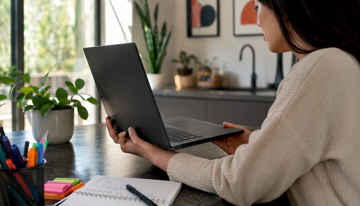 Hands checking security locks on laptop