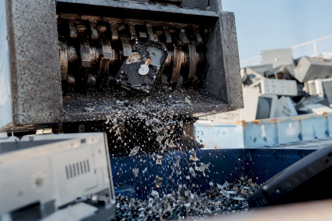 Hard drive being shredded in industrial machine