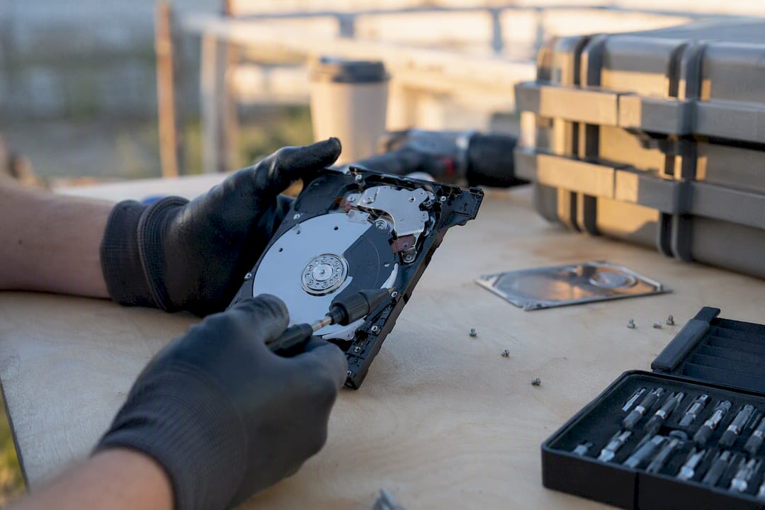 Hands verifying hard drive destruction details