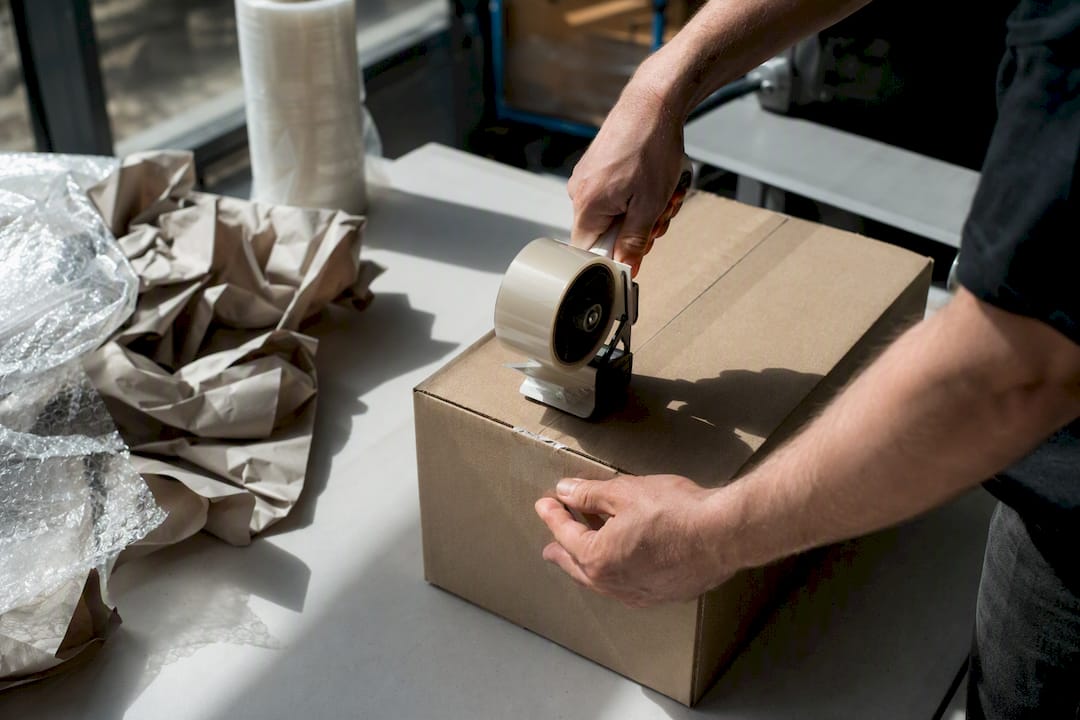 Hands sealing battery shipment box