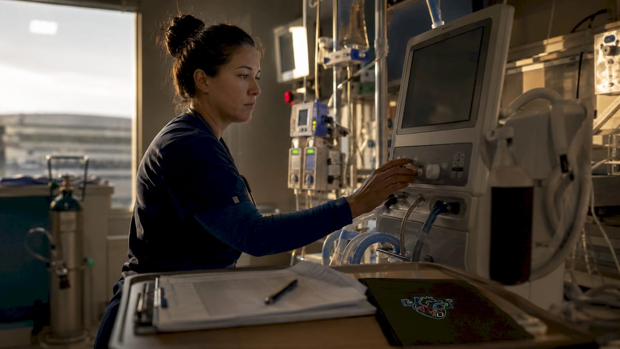 Respiratory therapist adjusting ventilator in ICU