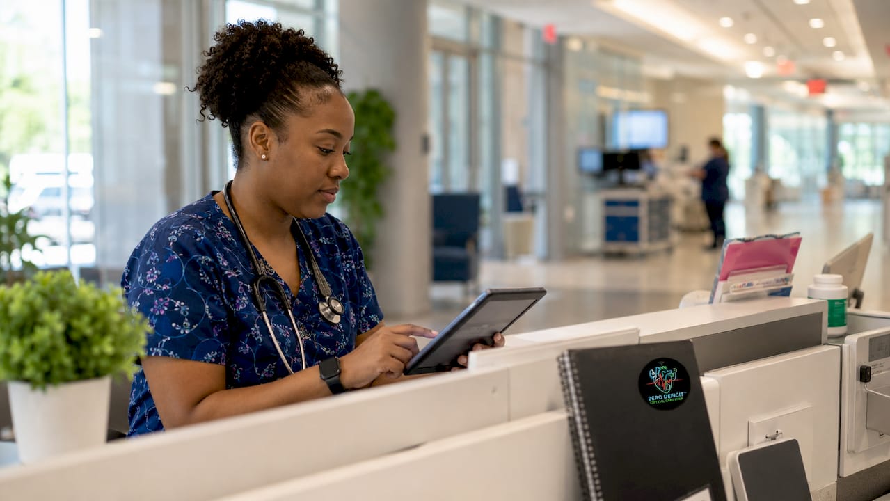 Nurse studying CCRN exam with tablet in hospital room
