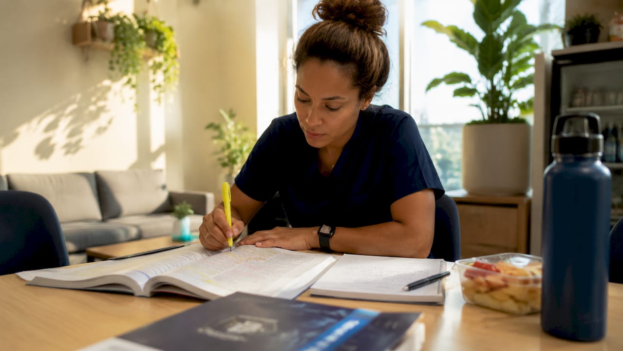 Focused nurse studying CCRN prep materials