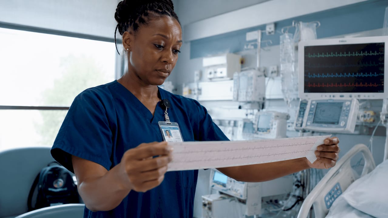 ICU nurse analyzing ECG rhythm strip
