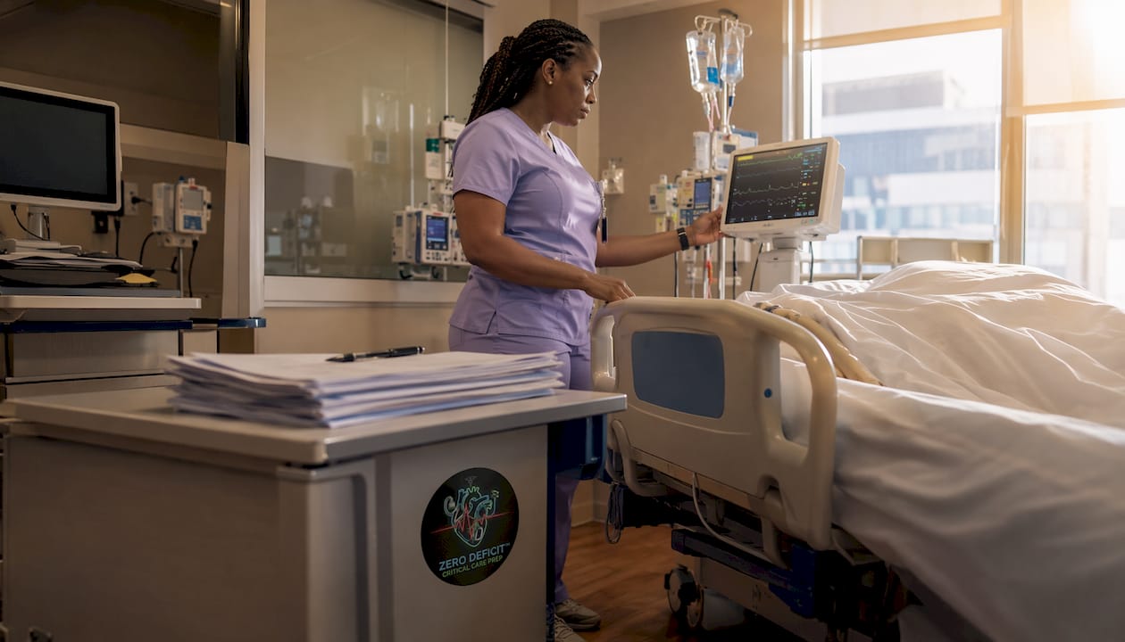 ICU nurse monitoring bedside vital signs