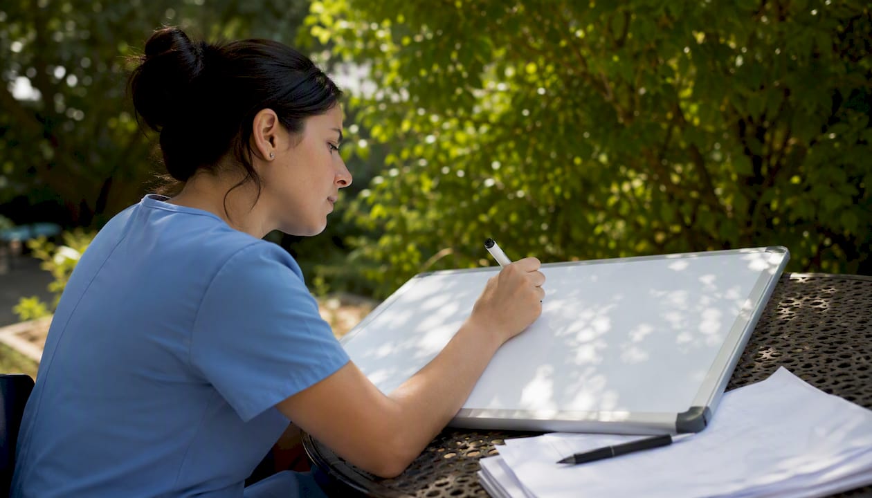 Nurse actively writing from memory during study