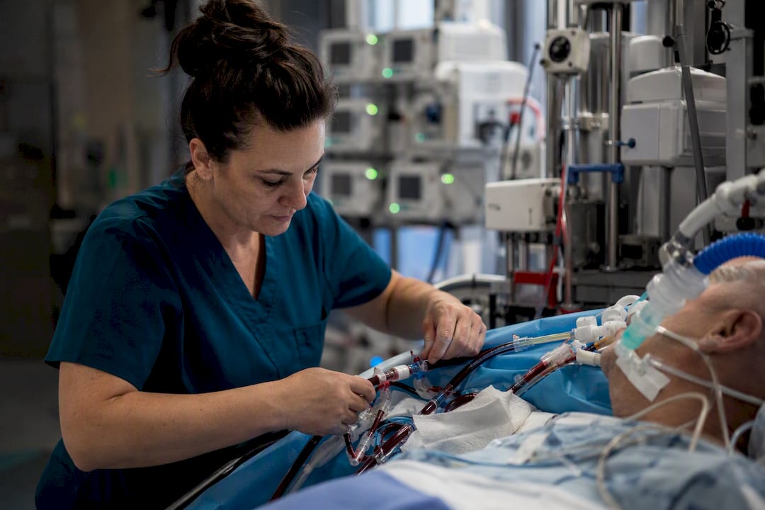 Nurse palpating cannula site on mechanical circulatory support