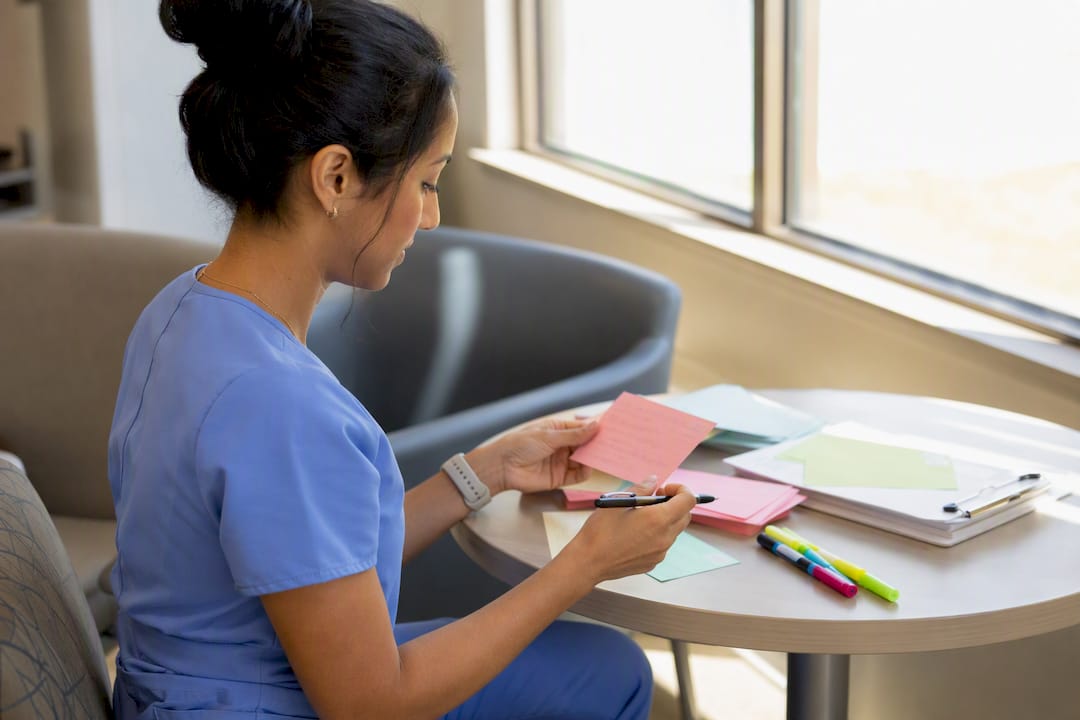 Nurse manually creating study flashcards